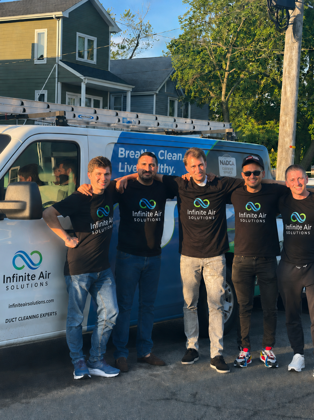 The Infinite Air Solutions duct cleaning team in front of their service van